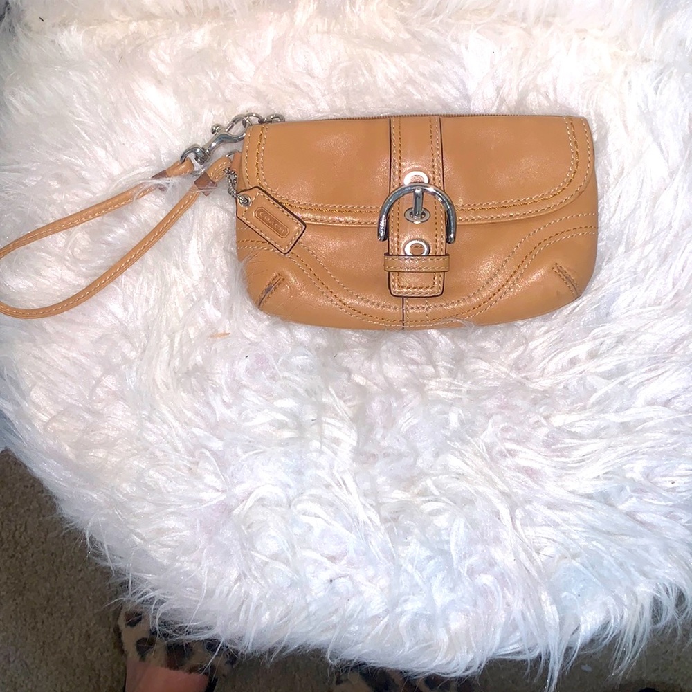 Coach tan with silver accent very tiny wristlet. Used maybe 1 time, if that.